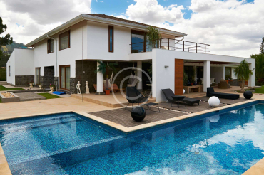 Geometric pool design using brick with gazebo & decorative lighting